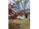Charming home featuring a freshly painted white brick exterior, new roof, and beautiful landscaping at 3735 Stonehaven Dr, Charlotte, NC 28215
