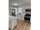 Kitchen features modern appliances, a white center island, and wood flooring at 3735 Stonehaven Dr, Charlotte, NC 28215