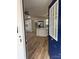 Inviting entryway view into a kitchen with white cabinetry, island, and modern appliances at 3735 Stonehaven Dr, Charlotte, NC 28215