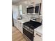 Close-up of stainless steel appliances, marble backsplash, and granite counters at 3735 Stonehaven Dr, Charlotte, NC 28215