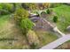 An aerial view of a charming home with well-maintained landscaping and a circular driveway on a large lot with mature trees at 3987 Taxahaw Rd, Lancaster, SC 29720