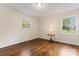 Comfortable bedroom with hardwood floors, large windows, and a classic lamp on a table at 3987 Taxahaw Rd, Lancaster, SC 29720