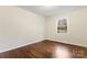 Sunlit bedroom with beautiful wood floors and a large window offering a view of the outdoors at 3987 Taxahaw Rd, Lancaster, SC 29720
