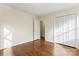 This is a spacious bedroom with beautiful wood floors and a view into an adjacent room at 3987 Taxahaw Rd, Lancaster, SC 29720