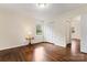 This bedroom features hardwood floors, windows, and a closet with a lamp on a table at 3987 Taxahaw Rd, Lancaster, SC 29720