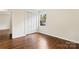 Charming bedroom featuring wood floors, bright window, and a closet for storage solutions at 3987 Taxahaw Rd, Lancaster, SC 29720