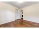 Cozy bedroom featuring wood floors, ample closet space, and a view into an adjacent room at 3987 Taxahaw Rd, Lancaster, SC 29720
