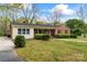Well-maintained brick home with green lawn, mature trees, and brick accents at 3987 Taxahaw Rd, Lancaster, SC 29720