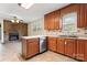 Bright kitchen features wood cabinets, a tile backsplash, stainless steel appliances, and views into living room at 3987 Taxahaw Rd, Lancaster, SC 29720