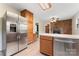 This kitchen features stainless steel appliances, wood cabinets, and an open floor plan leading to the living room at 3987 Taxahaw Rd, Lancaster, SC 29720