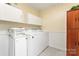 Bright laundry room with washer, dryer, storage cabinets and vintage wooden storage cabinet at 3987 Taxahaw Rd, Lancaster, SC 29720