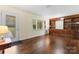 Bright living room featuring hardwood floors and built-in shelving at 3987 Taxahaw Rd, Lancaster, SC 29720