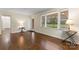 Open living area featuring hardwood floors, large windows, and neutral paint at 3987 Taxahaw Rd, Lancaster, SC 29720