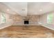Spacious finished basement area featuring a brick fireplace and mantle, wood-look flooring, and recessed lighting at 5316 Teakwood Dr, Kannapolis, NC 28083