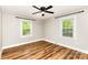 Bedroom features two windows for natural light, a ceiling fan, and wood grain floors at 5316 Teakwood Dr, Kannapolis, NC 28083