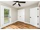 Bedroom features a ceiling fan, wood grain floors, and outdoor access to the backyard at 5316 Teakwood Dr, Kannapolis, NC 28083