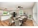 Inviting dining area featuring hardwood floors, modern lighting, and views of a bright and airy kitchen at 5316 Teakwood Dr, Kannapolis, NC 28083