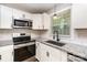 Updated kitchen with white cabinetry, granite countertops, subway tile backsplash, and stainless steel appliances at 5316 Teakwood Dr, Kannapolis, NC 28083