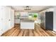 Modern kitchen featuring a center island, stainless steel appliances, white cabinets, and a sliding door to the deck at 5316 Teakwood Dr, Kannapolis, NC 28083