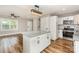 Open-concept living area with a view of the kitchen island, stainless steel appliances, and a spacious living area at 5316 Teakwood Dr, Kannapolis, NC 28083