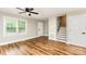 Bright living room featuring beautiful wood-look floors, a large window, and a view of the stairway at 5316 Teakwood Dr, Kannapolis, NC 28083