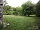 Lush backyard with mature trees and ample green space offers a serene outdoor setting at 613 E 5Th St, Spencer, NC 29159