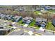 This aerial view shows a beautiful neighborhood with green lawns, and mature trees in the spring time at 7116 Brookline Pl, Huntersville, NC 28078