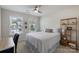 This bedroom offers a bed with a white comforter, two windows, desk, and a bookshelf with decor at 7116 Brookline Pl, Huntersville, NC 28078