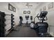 Home exercise room with weight rack, stationary bikes, punching bag, and treadmill on a black floor at 7116 Brookline Pl, Huntersville, NC 28078