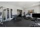 Bright exercise room with weight equipment, treadmill, elliptical, and free weights, perfect for home workouts at 7116 Brookline Pl, Huntersville, NC 28078