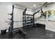 Fully equipped exercise room with weightlifting equipment and a bench on top of a dark rubber floor at 7116 Brookline Pl, Huntersville, NC 28078