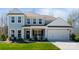 Charming two-story home with light blue siding, white trim, a well-manicured lawn, and an attached two-car garage at 7116 Brookline Pl, Huntersville, NC 28078