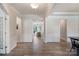Spacious foyer with hardwood floors, white trim, and an open view into the living spaces beyond at 7116 Brookline Pl, Huntersville, NC 28078