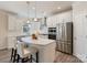 Modern kitchen with white cabinets, stainless steel appliances, and an island with pendant lighting and seating at 7116 Brookline Pl, Huntersville, NC 28078