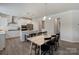 Spacious eat-in kitchen with white cabinets, stainless steel appliances, and a large dining table at 7116 Brookline Pl, Huntersville, NC 28078