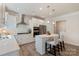 Bright, modern kitchen features white cabinets, stainless steel appliances, and a stylish center island with seating at 7116 Brookline Pl, Huntersville, NC 28078