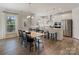 Open-concept kitchen with white cabinets, stainless steel appliances, and an island with bar seating at 7116 Brookline Pl, Huntersville, NC 28078