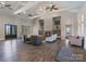Spacious living room with high ceilings, fireplace, hardwood floors, and comfortable seating at 7116 Brookline Pl, Huntersville, NC 28078