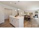 Open floor plan connects the kitchen island to the living and dining areas, offering spacious living at 7116 Brookline Pl, Huntersville, NC 28078