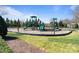 View of playground with green slides and climbing structure surrounded by mulch and grass at 7116 Brookline Pl, Huntersville, NC 28078