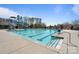 A clear pool featuring water slides and a splash area, surrounded by concrete and landscaping at 7116 Brookline Pl, Huntersville, NC 28078