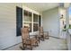 Inviting front porch featuring rocking chairs and a small table creating a cozy outdoor living space at 7116 Brookline Pl, Huntersville, NC 28078