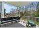 Relax on the screened porch with comfortable seating and views of the backyard at 7116 Brookline Pl, Huntersville, NC 28078