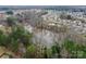 An aerial view of a pond in the community bordered by trees at 8606 Highgate Dr, Charlotte, NC 28215