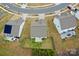 An aerial view of the home showcasing the fenced backyard, patio, and surrounding landscape at 8606 Highgate Dr, Charlotte, NC 28215