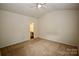 Neutral bedroom with carpet flooring, a ceiling fan, and access to the bathroom at 8606 Highgate Dr, Charlotte, NC 28215