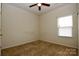 Cozy carpeted bedroom with a ceiling fan and natural light from a window at 8606 Highgate Dr, Charlotte, NC 28215