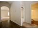 Bright hallway with wood-look flooring, leading to carpeted living areas and a bathroom at 8606 Highgate Dr, Charlotte, NC 28215