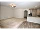 Open-concept living room with carpeted floors, ceiling fan, and adjacent kitchen area at 8606 Highgate Dr, Charlotte, NC 28215