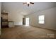 Bright living room featuring neutral carpets, a ceiling fan, and an open-concept layout at 8606 Highgate Dr, Charlotte, NC 28215